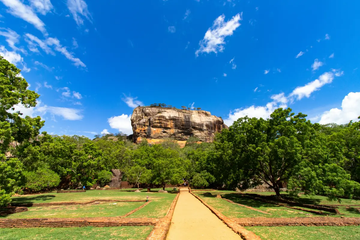 L’allée des jardins royaux qui mène au pied du Rocher de Sigiriya, sous un ciel bleu
